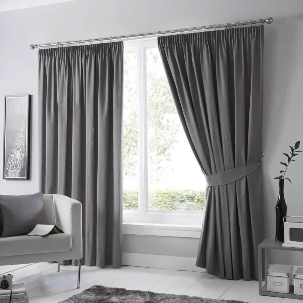 Stylish room with a window featuring dark gray curtains, letting light in