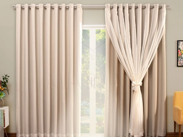Elegant brown curtains featuring Double Layered Blackout Curtains Dubai style with a sheer voile panel tied back in the center.
