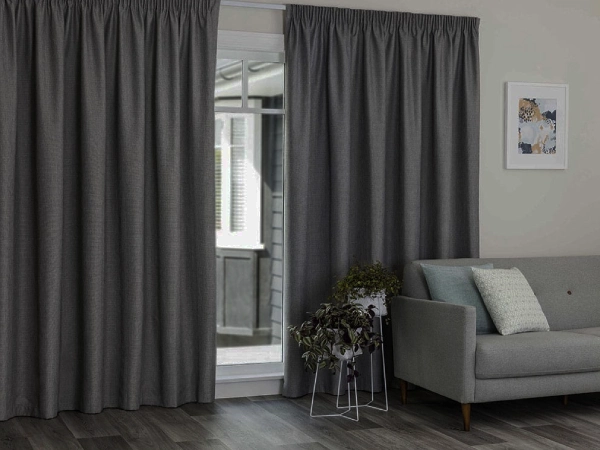 Grey pencil pleat Thermal-Insulating Blackout curtains Dubai style in a modern living room setting.