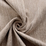 Mocha blackout curtain fabric spiraled in a fold, showing its textured