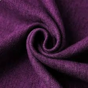 Plum blackout curtain fabric tightly swirled to show the rich color and textured, linen-look weave.