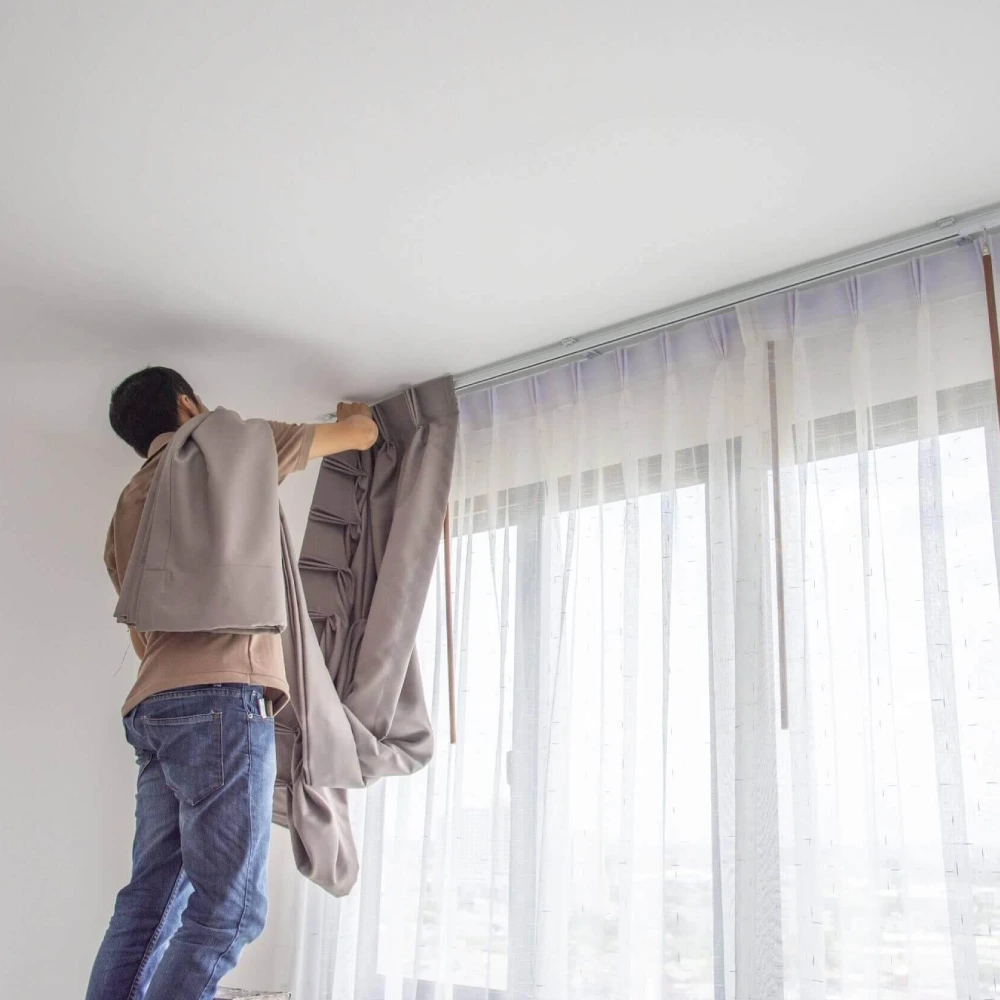 Professional curtains installation team fitting modern drapes for a clean, stylish and flawless window look.