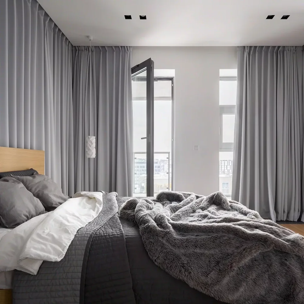 Stylish grey Blackout curtains Dubai ensuring luxury and Thermal insulation in the master suite.