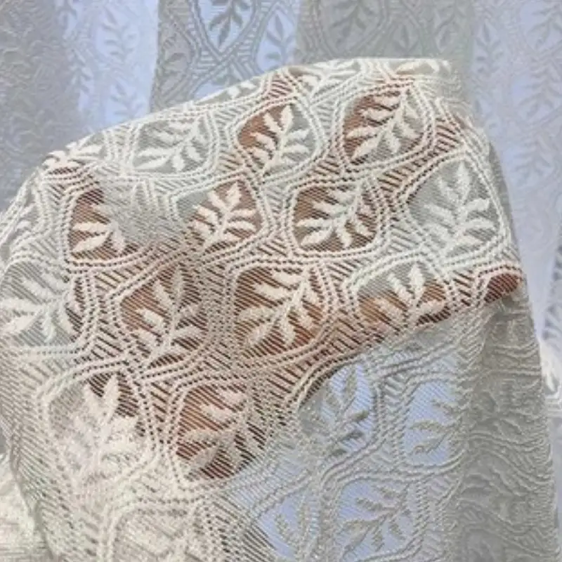 Intricate Lace Net sheer Curtains featuring a delicate leaf pattern and elegant woven texture.