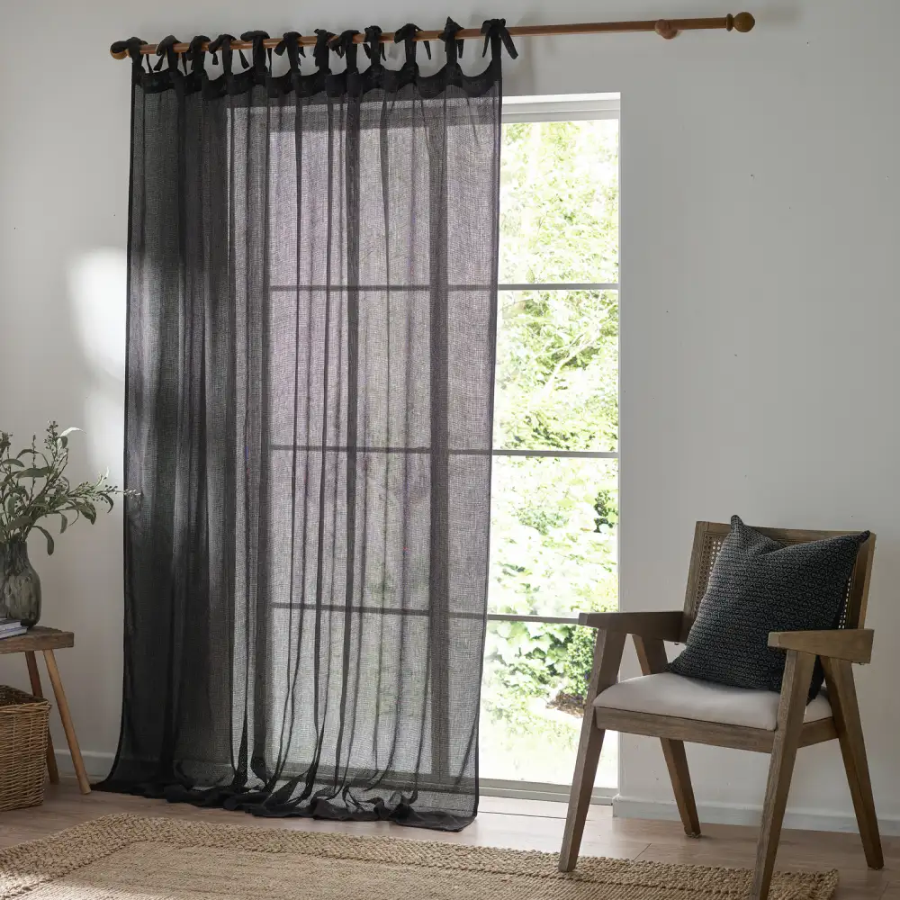 Black Tie Top sheer curtains creating a warm and airy ambiance.