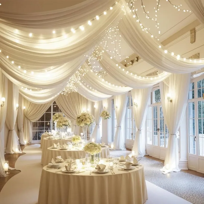 Custom length ballroom curtains with white drapes and warm string lights in a luxury venue.