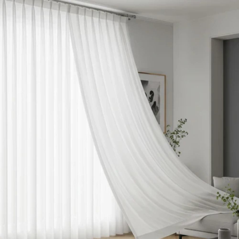 Light-filtering pinch pleat sheer curtains in a contemporary home interior.