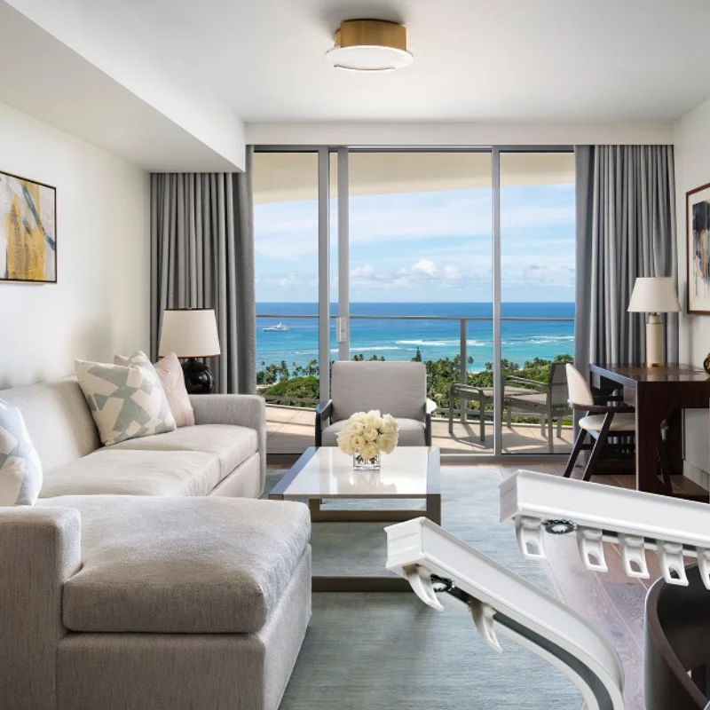 Luxury hotel suite with motorized sheer curtains over large glass doors for smart light control.