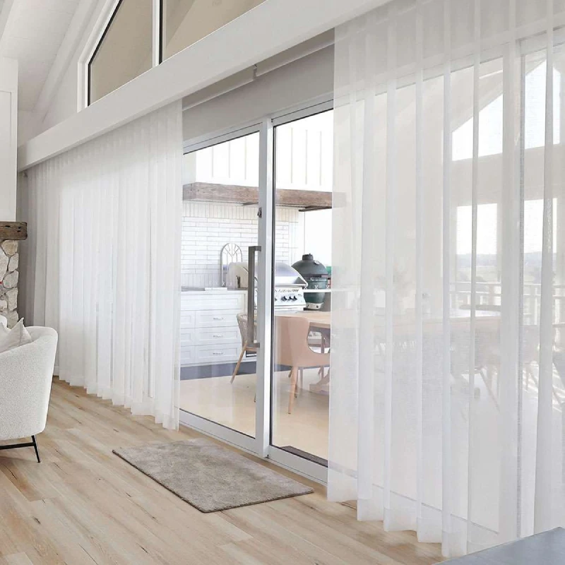 Luxury villa with motorized sheer curtains over sliding doors for elegant, automated light control.