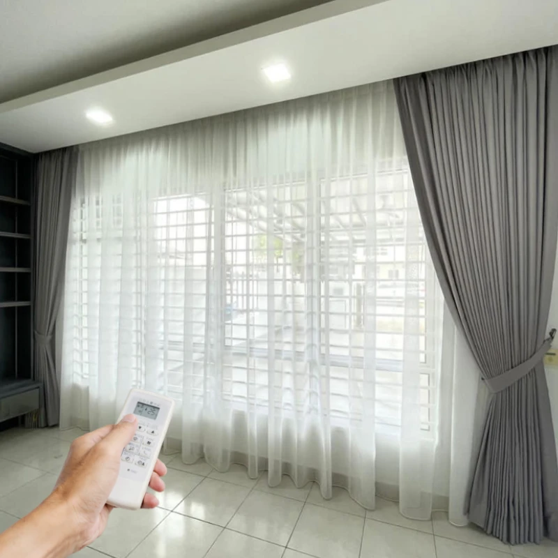 Modern living room with grey sheer & blackout motorized curtains automatically closing.