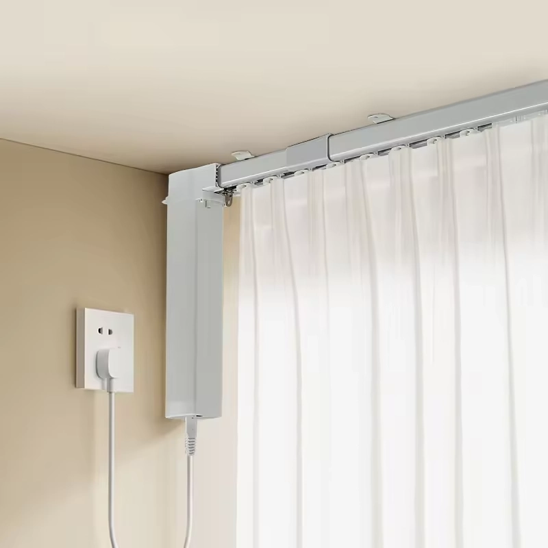 Wired motorized curtains with white sleek track and side power cable.